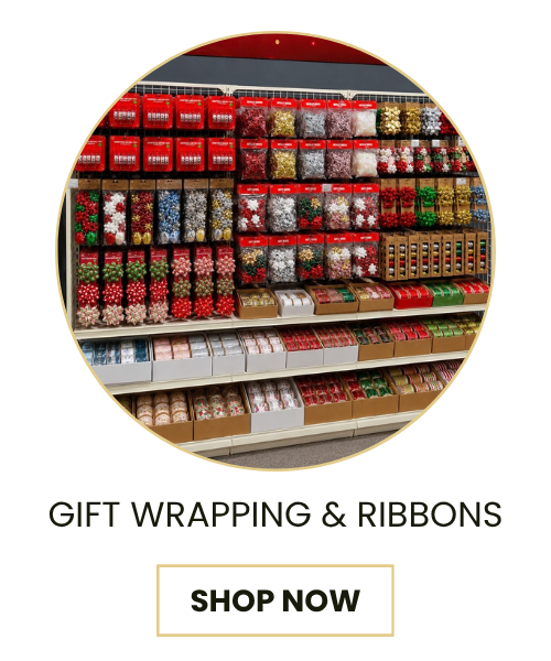 A promotional graphic showing a circular photo of shelves stocked with colorful gift wrapping paper and ribbon packages, with the text 'GIFT WRAPPING & RIBBONS' and a 'SHOP NOW' button below on a white background.